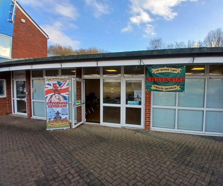 Entrance of a building with a Union Jack and signage for "Stevenage".